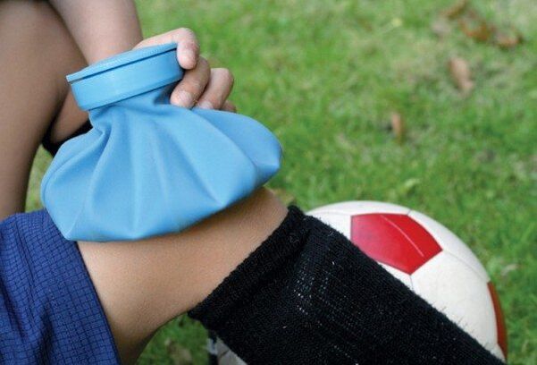 Applying a cold compress to a knee injury