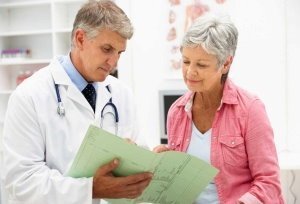 A woman with arthritis on examination by a doctor